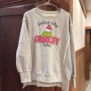 Ladies Boutique Grinch Shirt. High Low seam with sleeve detail.